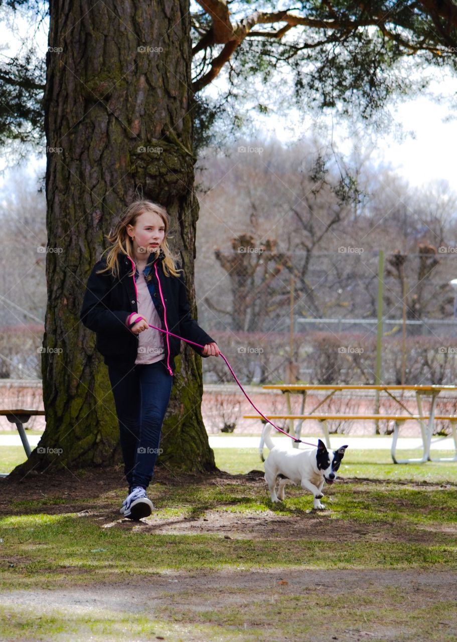 Walking. Girl is walking with her dog in the park