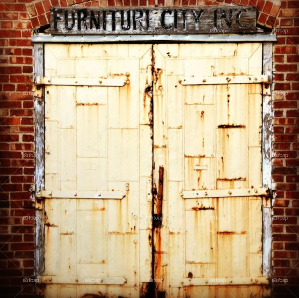 Old wooden door on an abandoned brick warehouse.