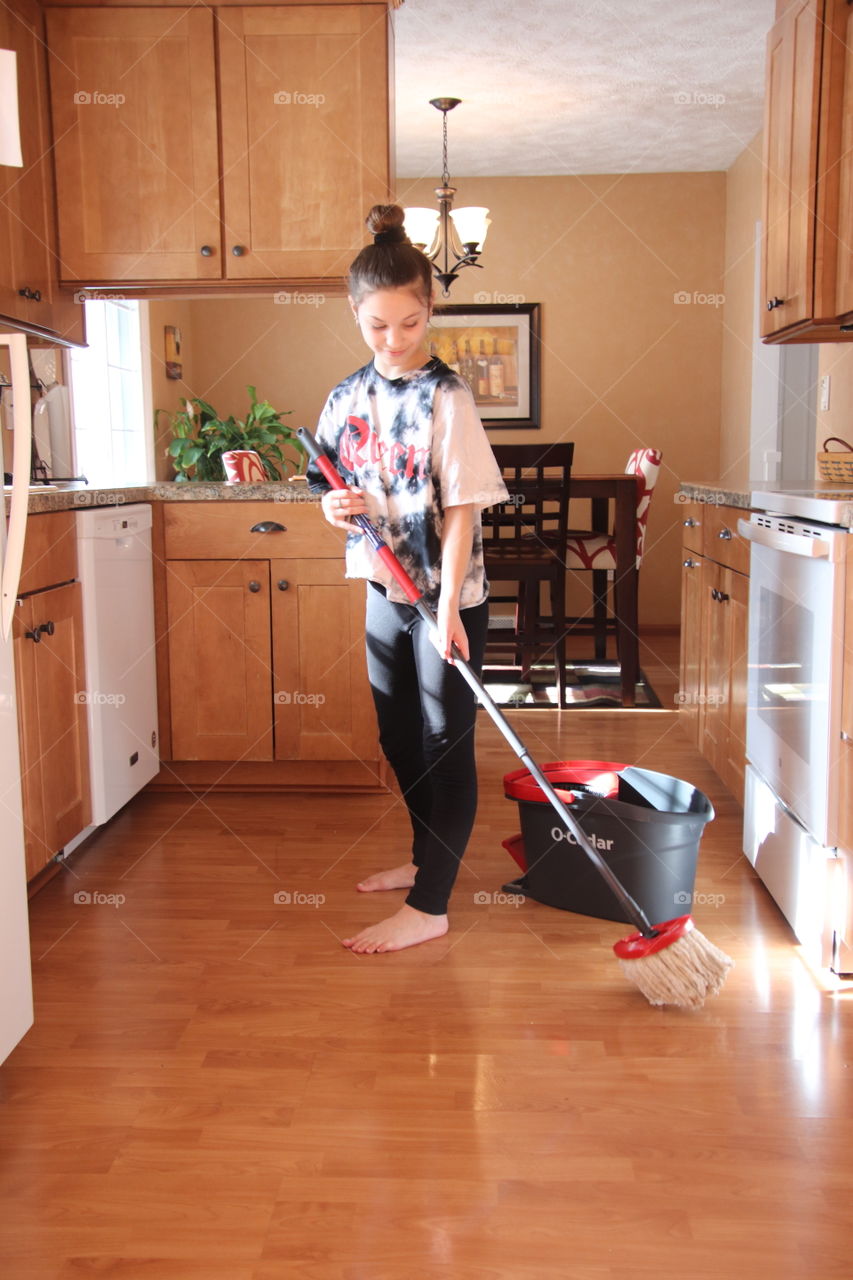 Girl using O-Cedar mop and bucket 