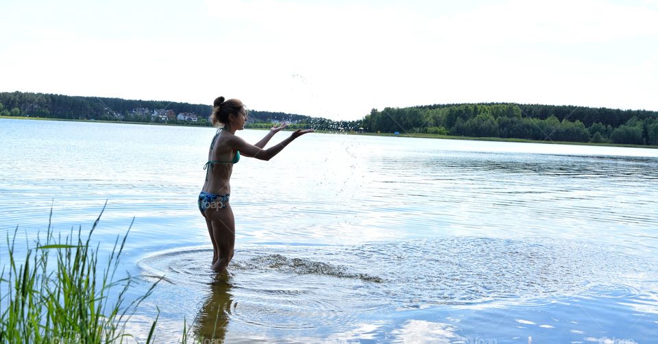 splash water lake girl relaxing on a nature summer heat, summer vacation