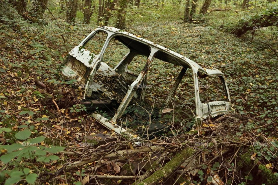 Lardy, France - Car abandoned in the forest at the beginning of autumn