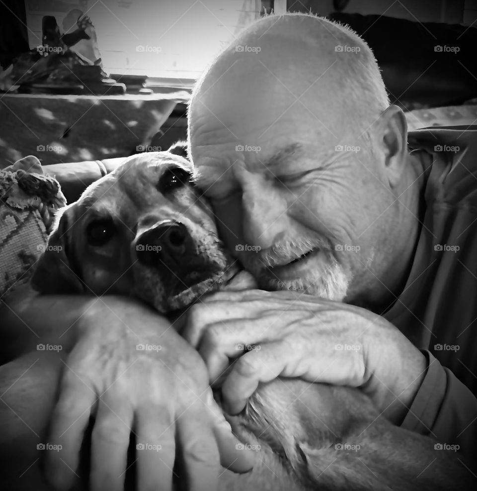 Tender pet moments. Nothing better than a man and his best friend. Closeup, black and white. 