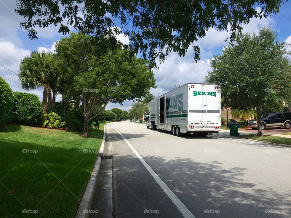 Moving. Moving truck parked on the street in front of house