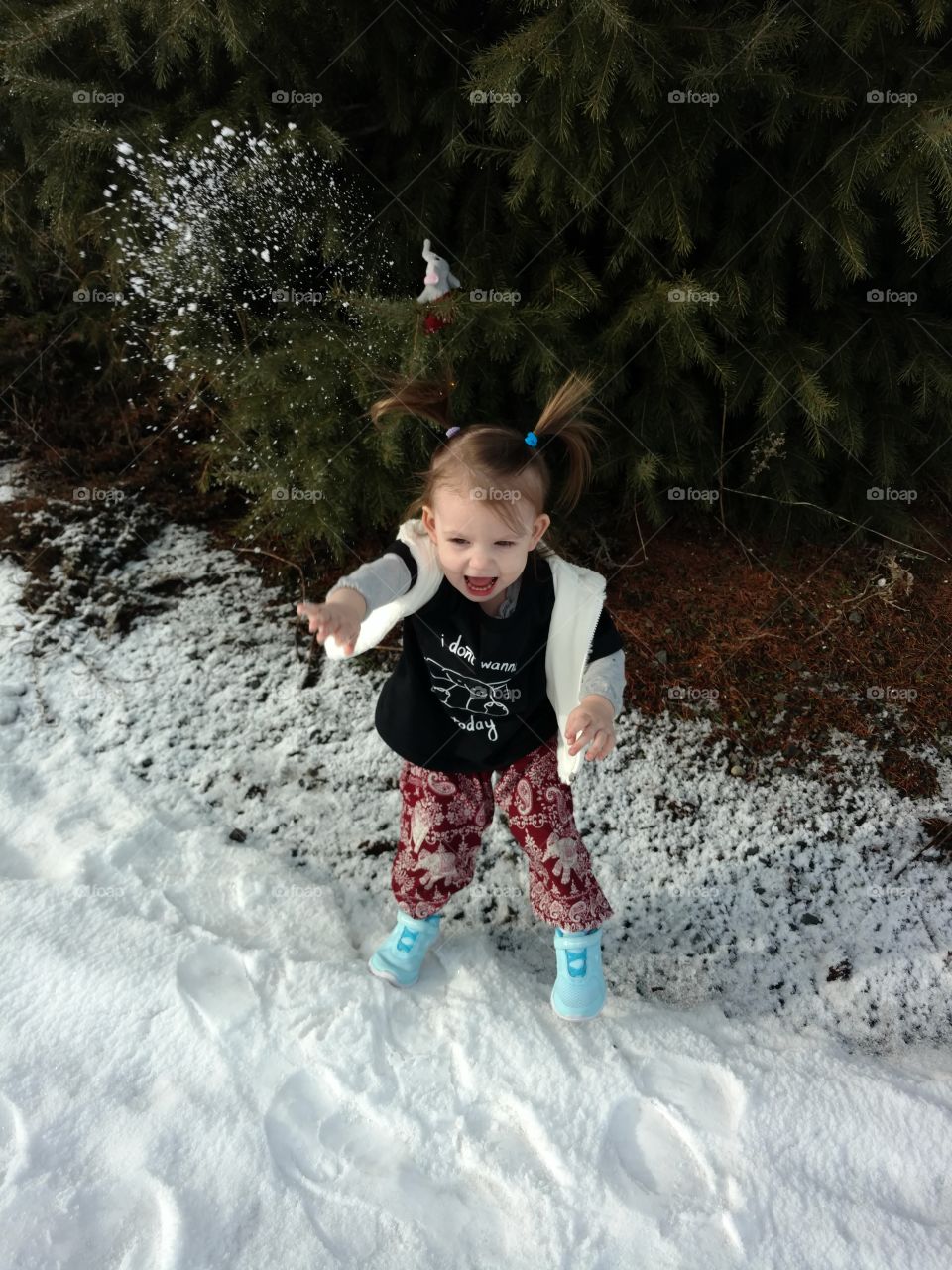 Cute girl playing with snow