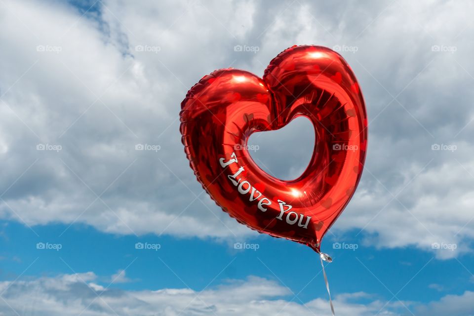 Close-up of red balloon against blue sky