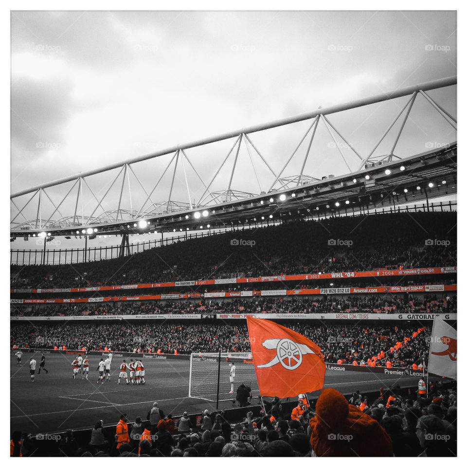 Arsenal score under a midday crowd at the Emirates stadium.