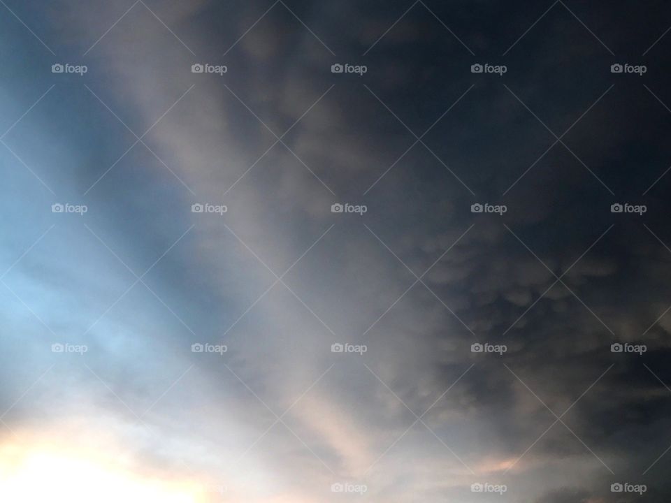 Thunderstorms moving in quickly to devour the sunset.