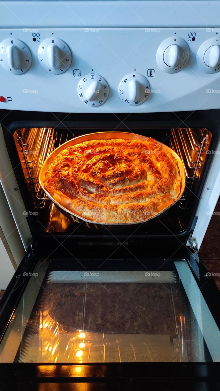 Baked cheese bread in the oven, traditional Bulgarian food called "banitza".