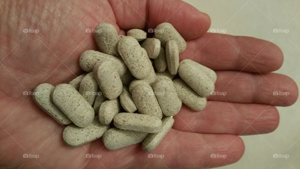 Close-up of person's hand with pills