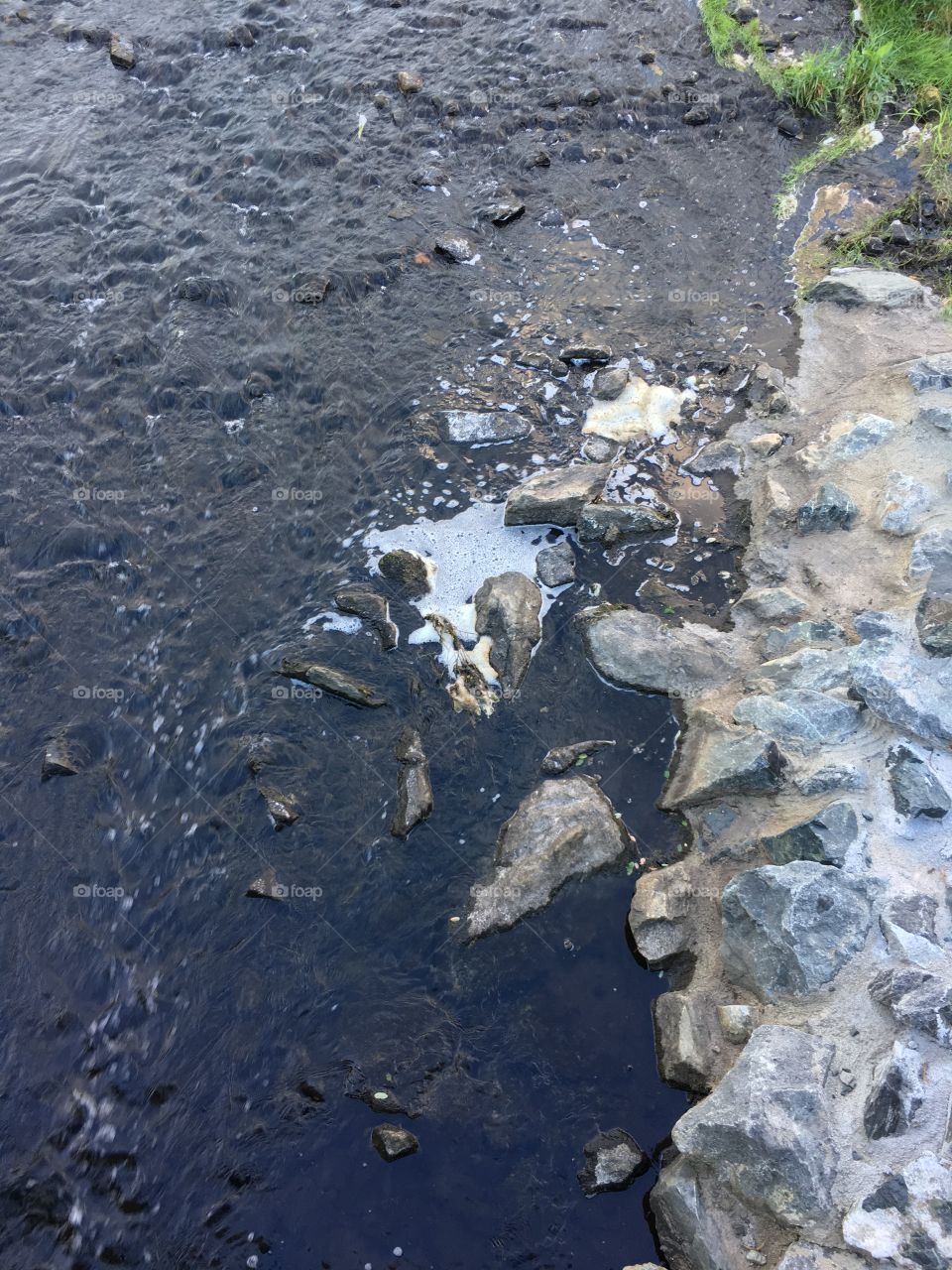 Rushing water flowing down from a waterfall at Butterfly Pond, dumping into a drain tunnel that goes under BreakNeck Hill Rd. (Lincoln, RI)