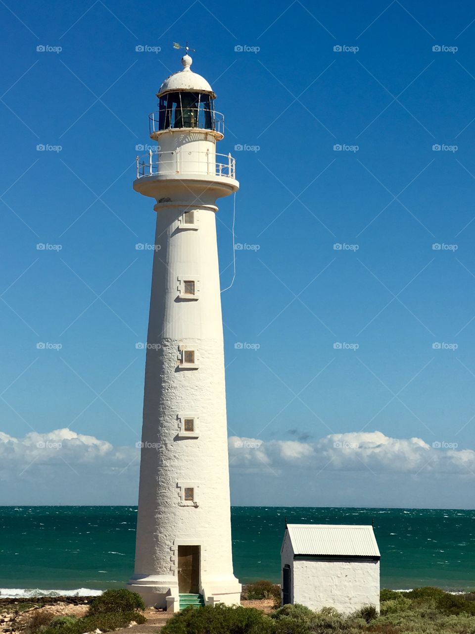 Tall white lighthouse on clear blue day, Point Lowly, South Australia