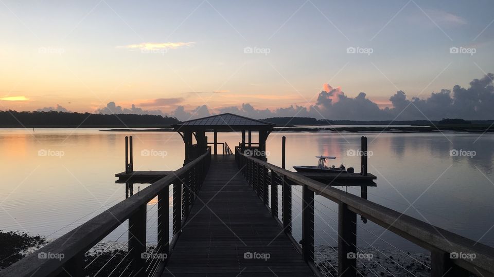 Calm and peaceful morning. Beautiful sunrise on the dock.