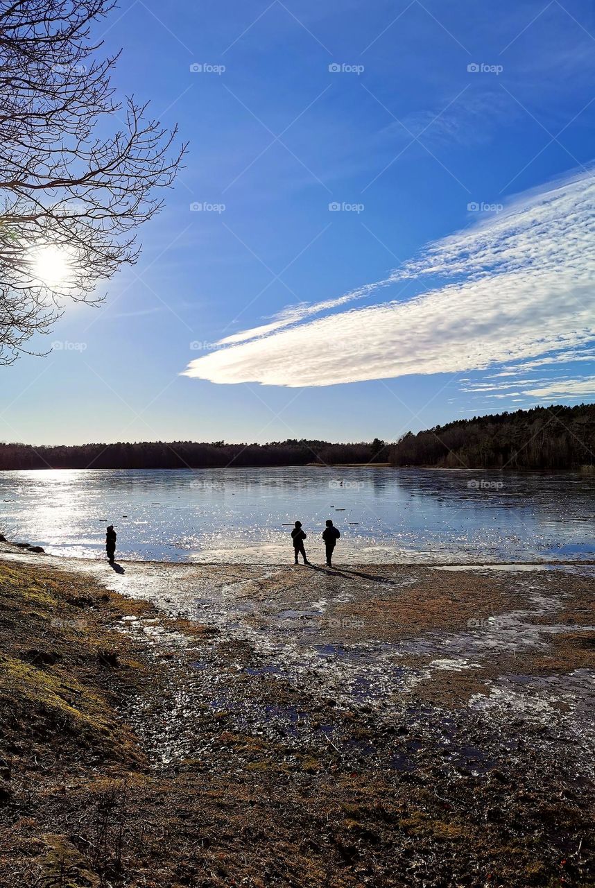 Children by the lake in winter time