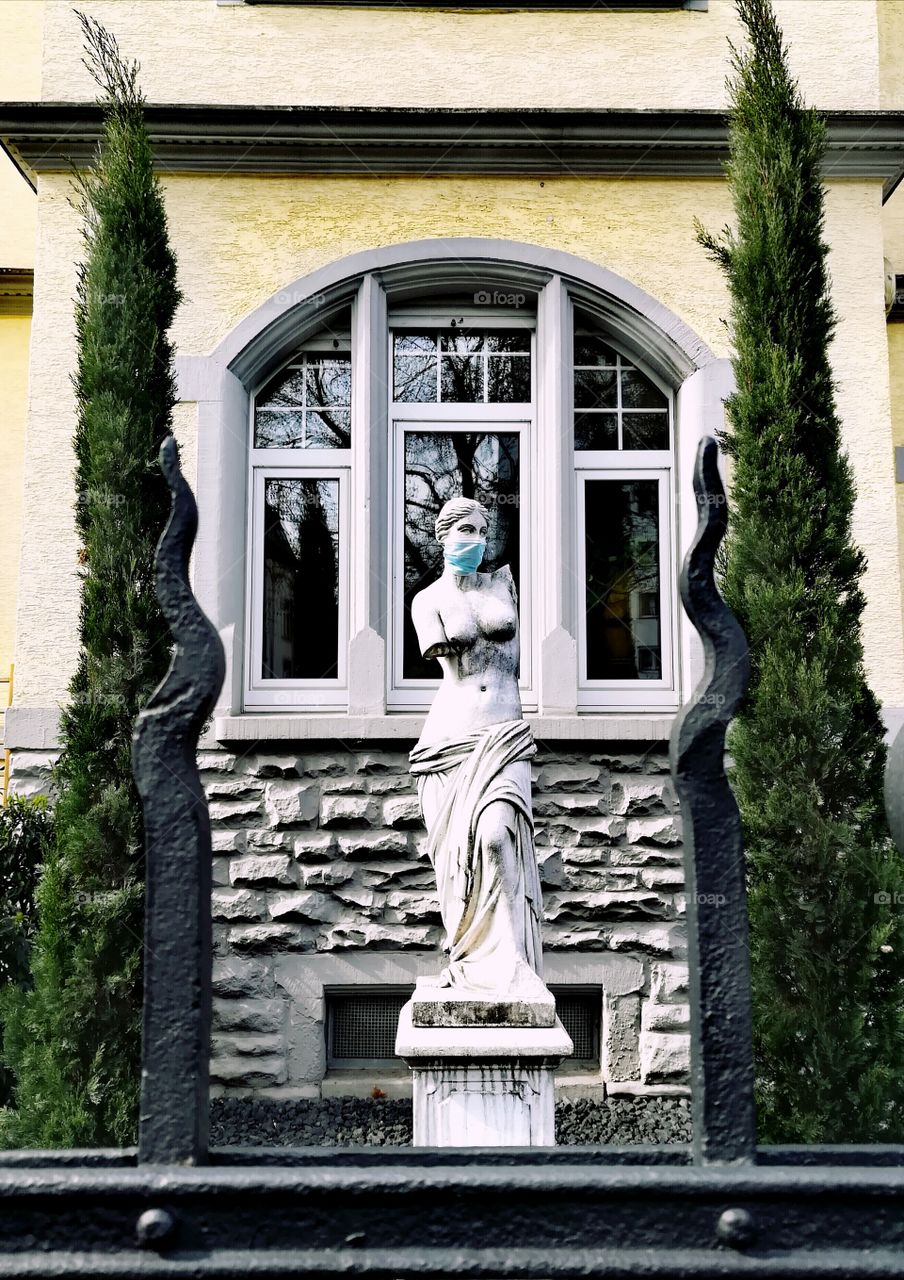 Statue with corona mask