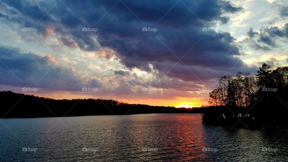 clouds during sunset on lake.