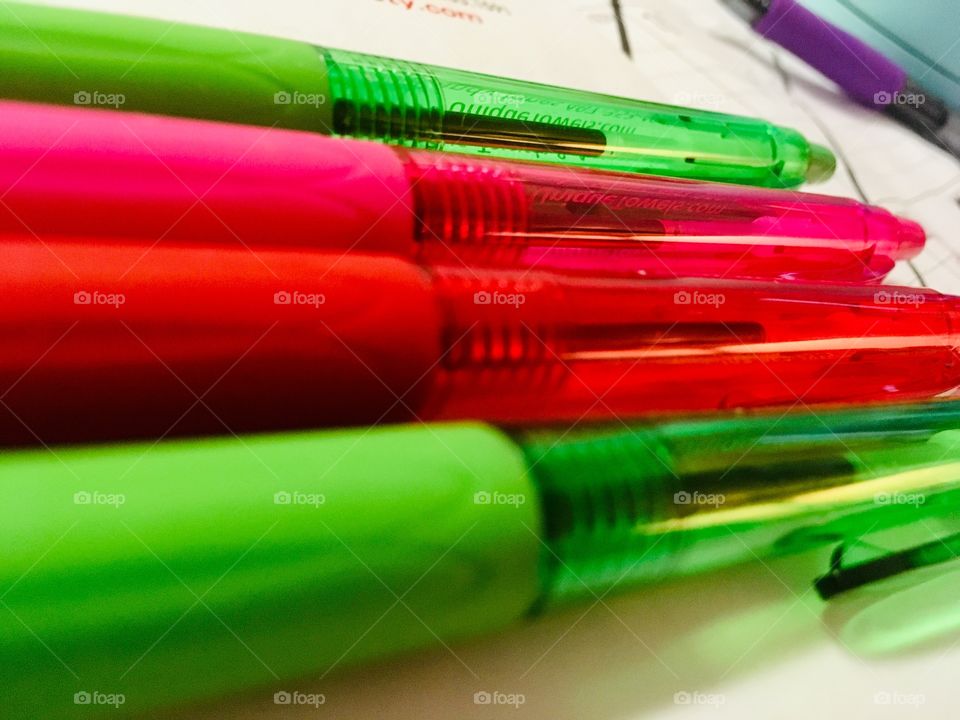 Green, pink, red and purple colored pens