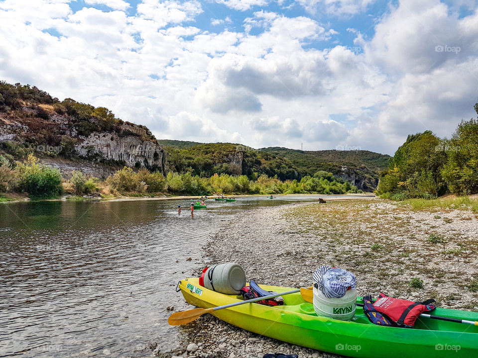 a colorful canoe lies on the river