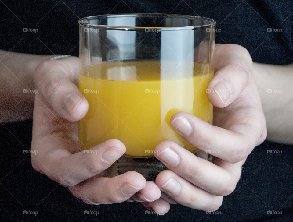 Woman holding a glass of orange juice