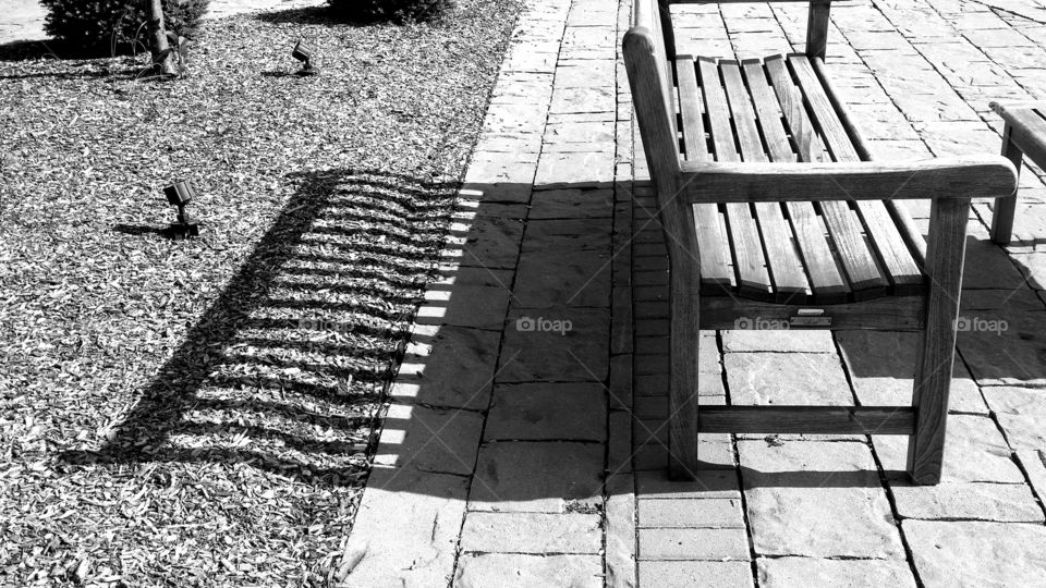 Park bench railings shadow on