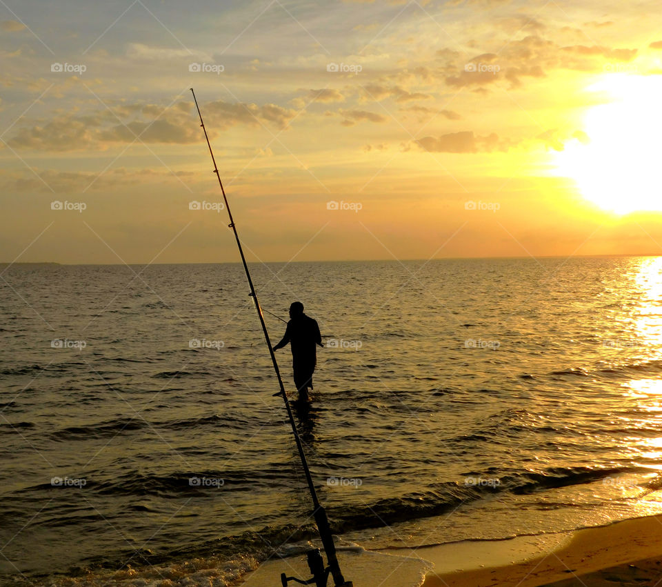 Fisherman fishing in sea