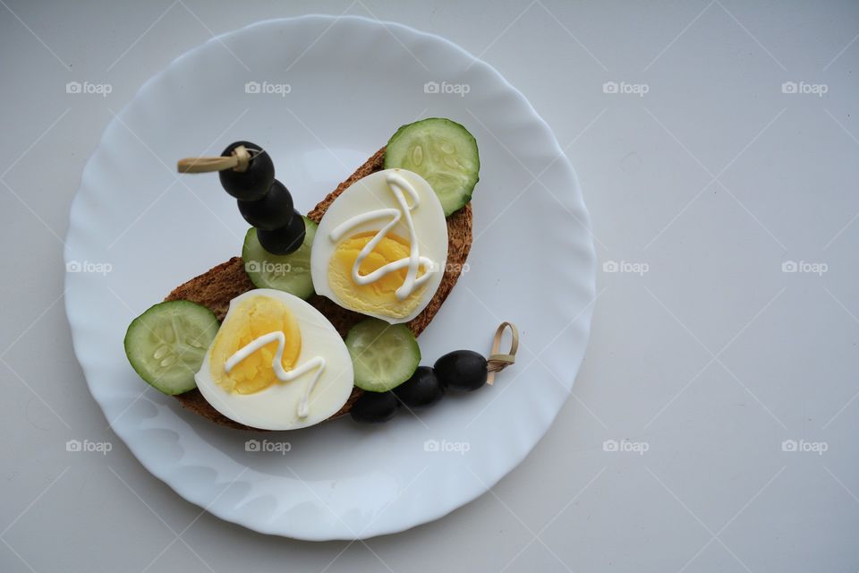 sandwiches with eggs and vegetables on a plate