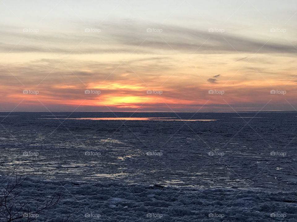 Sunset on Lake Erie covered in ice 