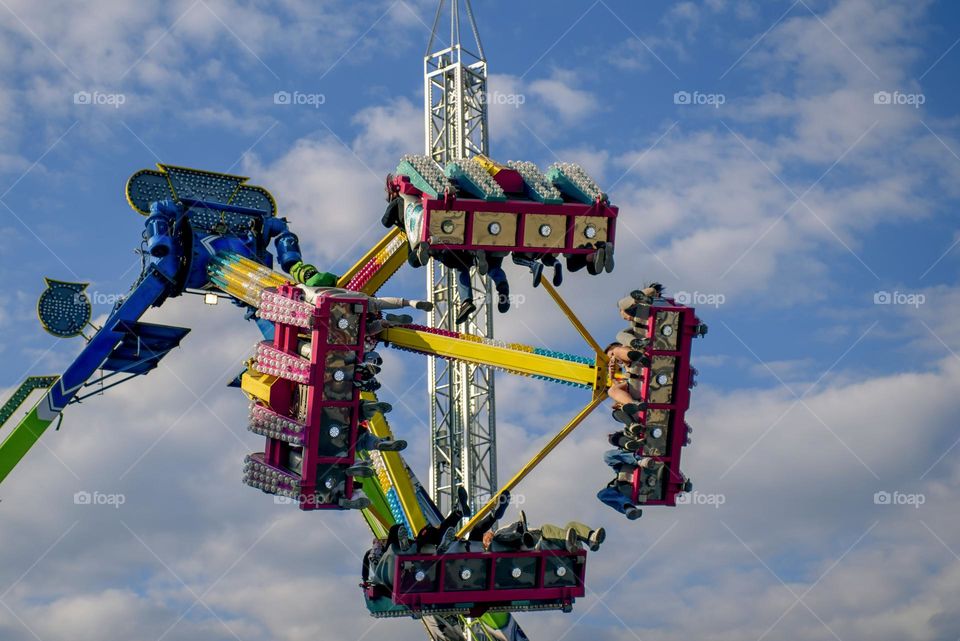 Air attraction against the blue sky and white clouds.  Amusement rides in Zielona Gora in Poland at the wine collection festival.