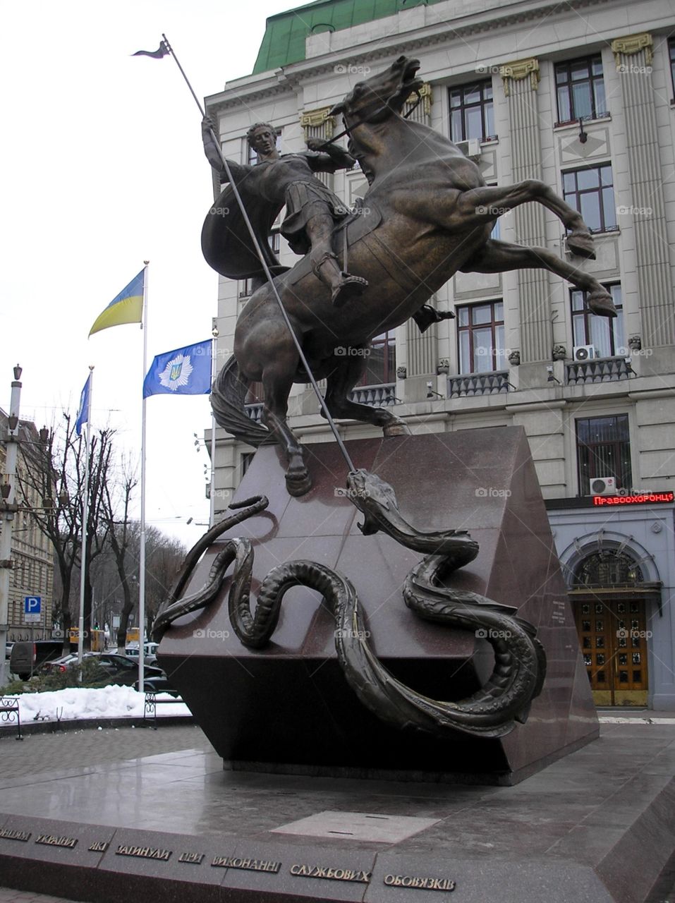 A statue of a hero fighting a snake  