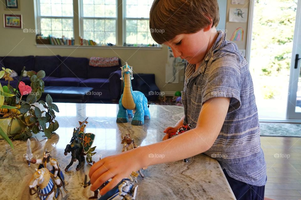 Young Boy Playing With Plastic Toys