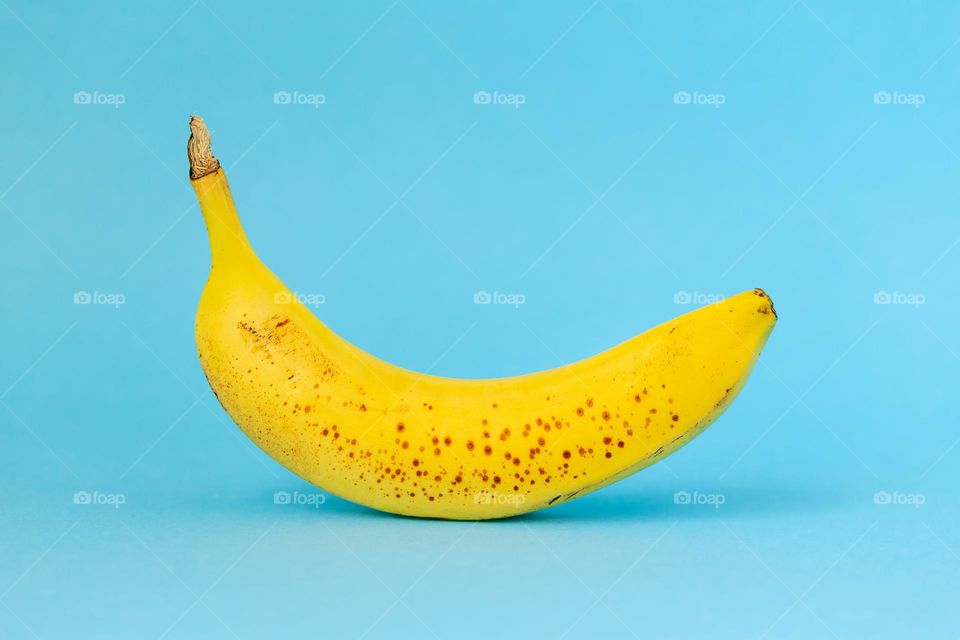 Yellow banana on blue background