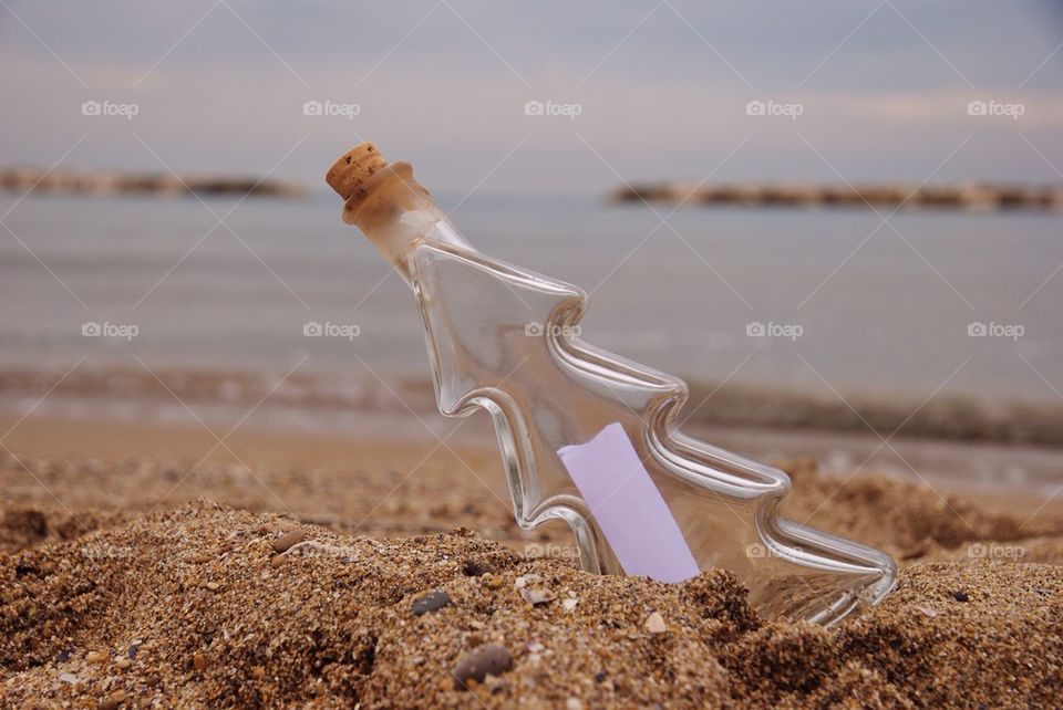 Close-up of bottle in beach