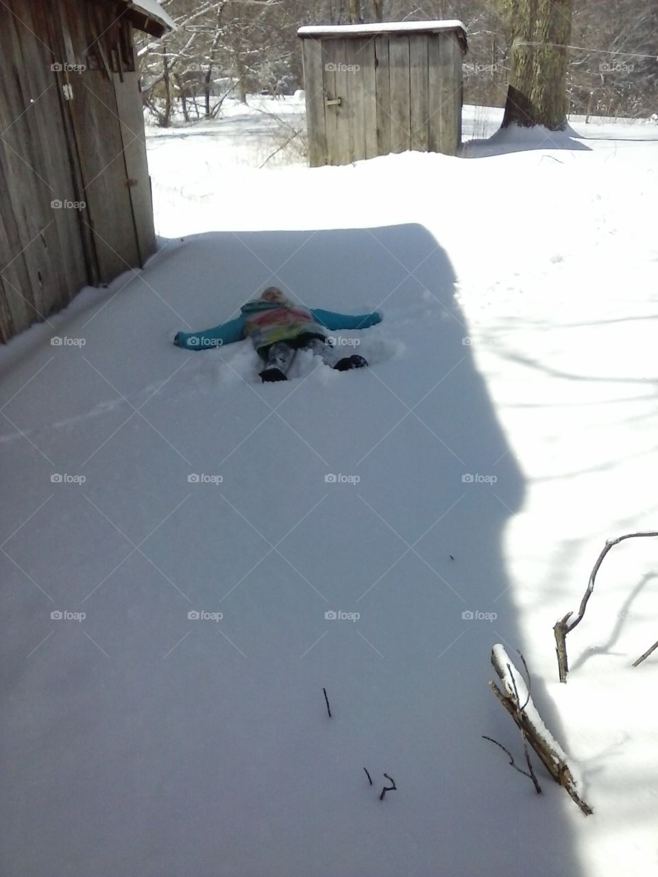 snow angel. small child making a shoe angel