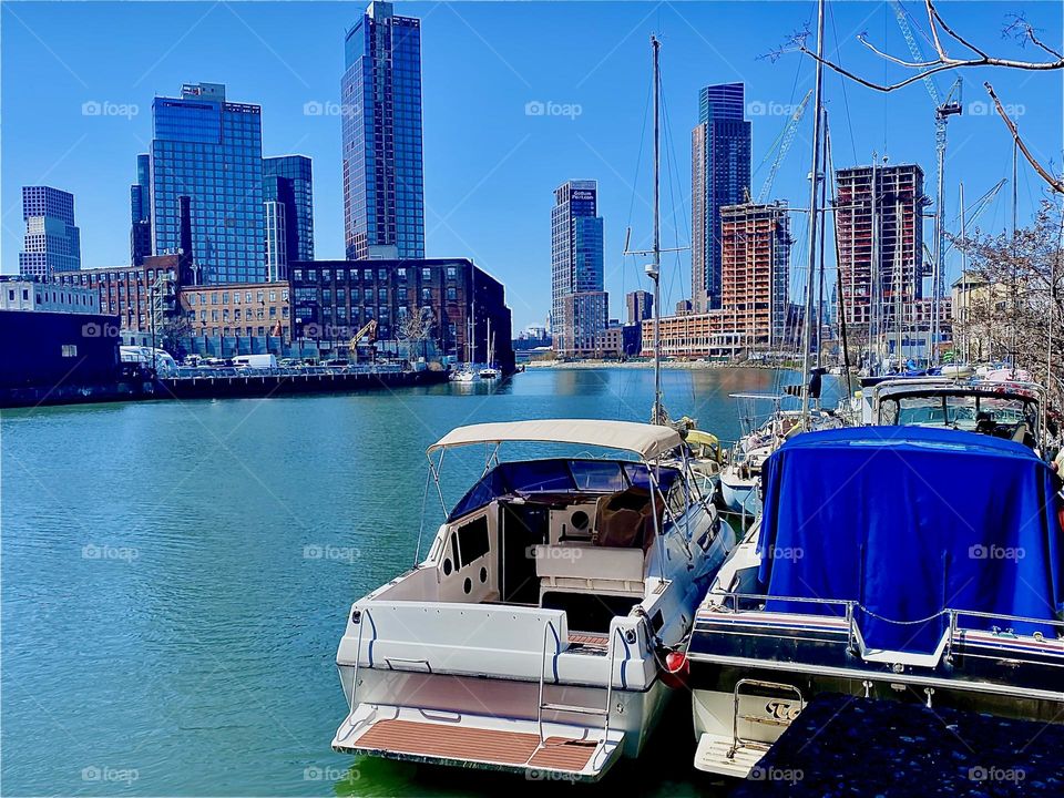 The ocean takes on a vibrant turquoise hue today as we are gazing down “Newtown Creek” by the “Pulaski Bridge” in the bright sunshine from overhead. 2023. Hypnotic Productions