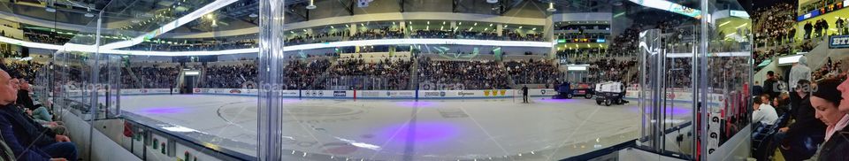 view of the ice from right behind the glass at Pegula ice arena