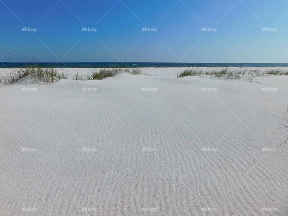 Lines in the sand, leading to the ocean - The white sand on the beach is made from pure white quartz crystal, which came from the Appalachian Mountains at the end of the last Ice Age and was deposited into the Gulf of Mexico