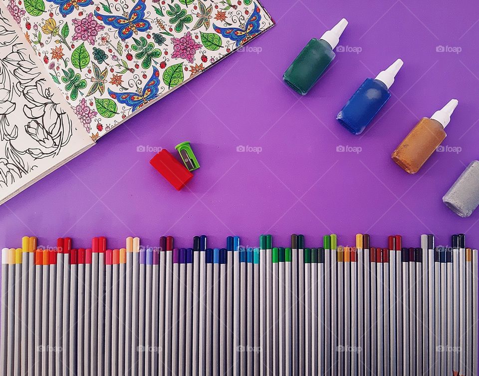 72 colored pencils, coloring book, sharpener and glitter glues.