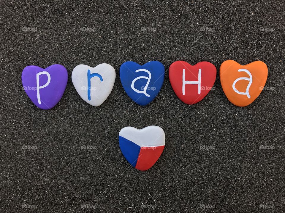 Praha, Czech Republic, souvenir with multicolored heart stones  and national flag design over black volcanic sand