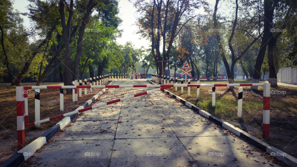 Barrier through a railway crossing