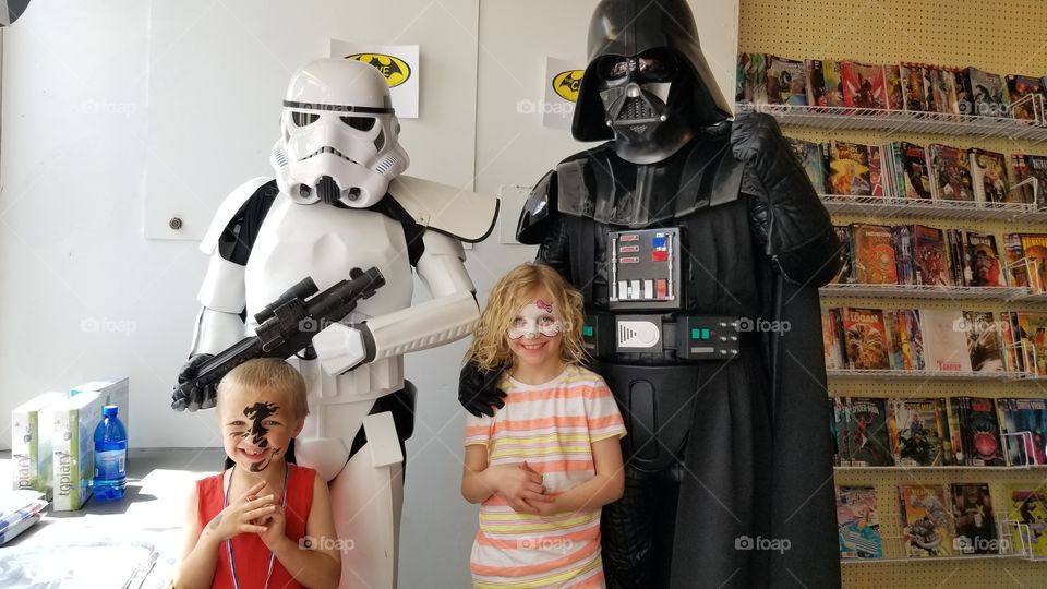 My two oldest, getting a photo op with Darth Vader and a Storm Trooper, at Free Comic Book Day.