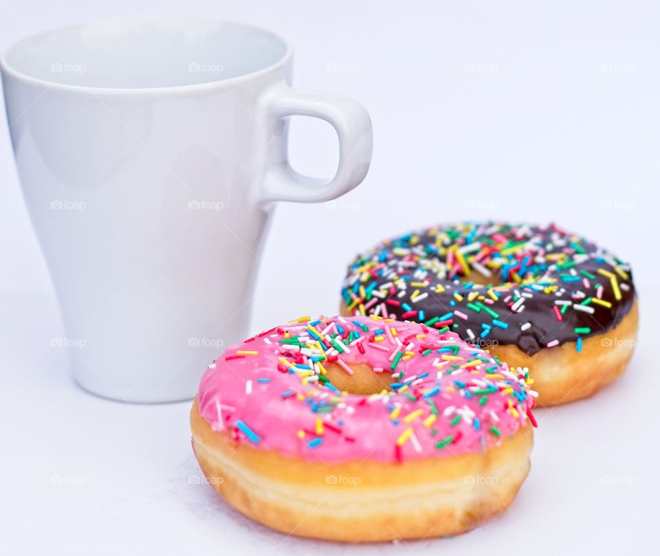 Colorful Doughnuts and a cup