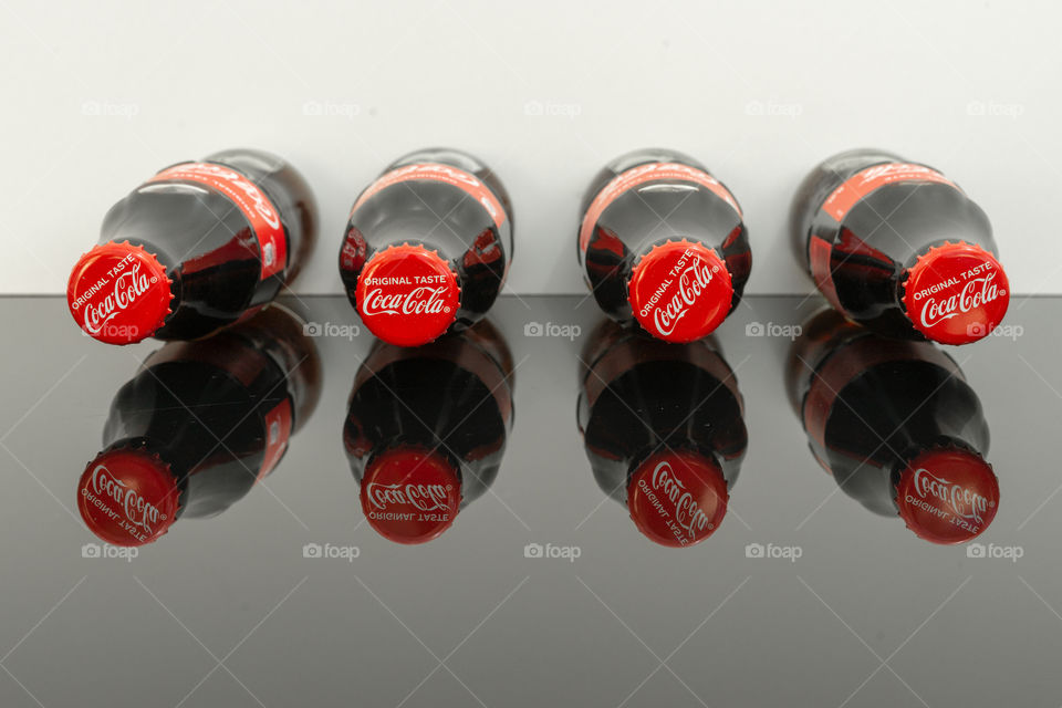 bottles of Coca Cola and reflection