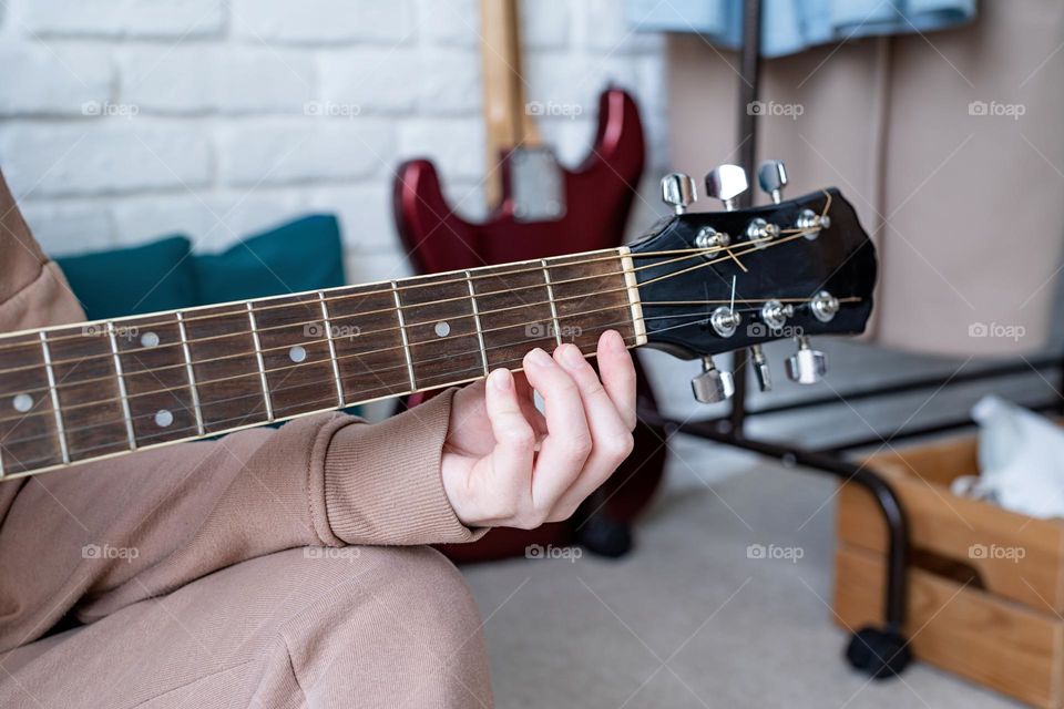 teen girl playing guitar