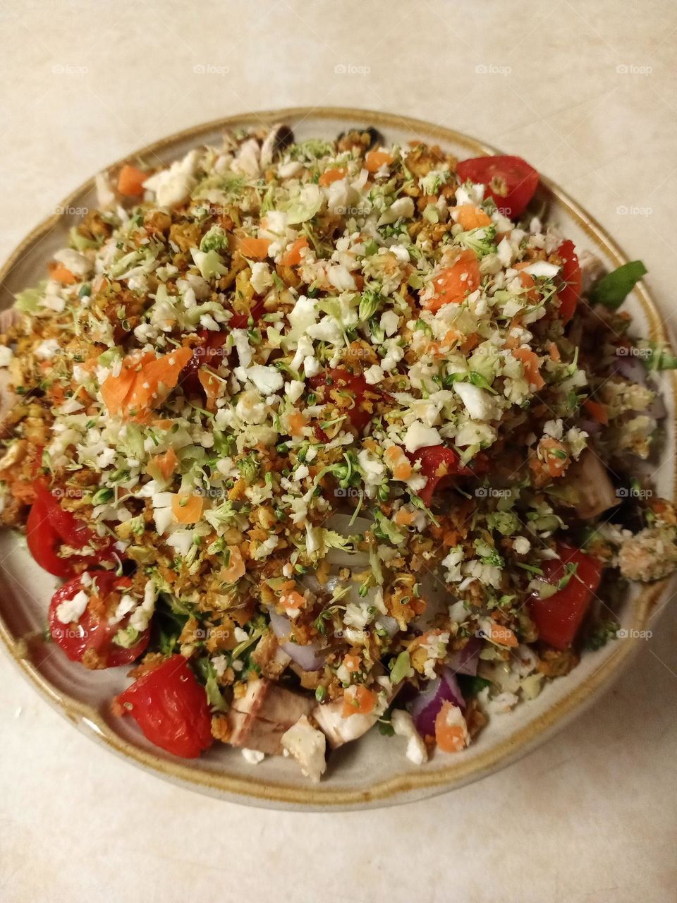 Homemade salad top with heart healthy broccoli, collieflower and carrots prepared by photographer and cook Mark Sarden