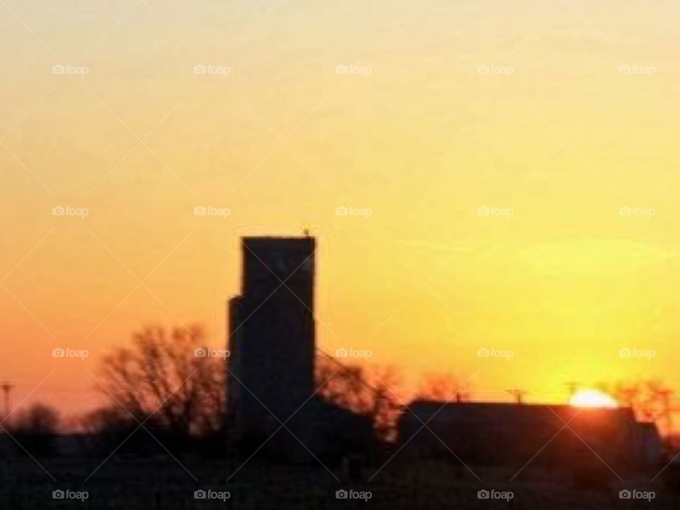 Farm Sunset. Driving home seeing this beautiful Silloette of a grain elevator as the sun sets!  