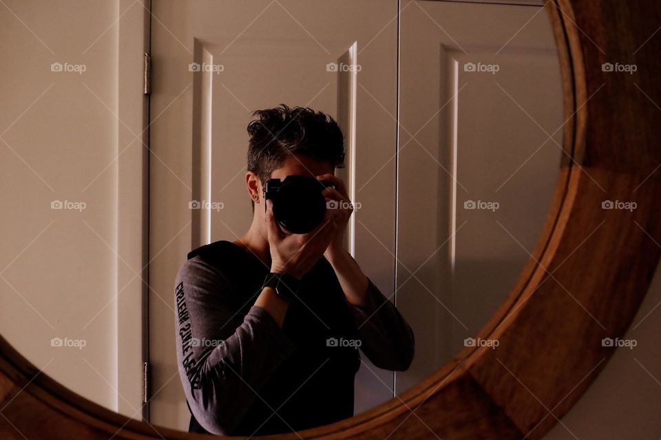 Photographer shoots into mirror, photographer with a camera, camera equipment reflections, seeing the possibilities, reflections of the camera, reflections in the mirror