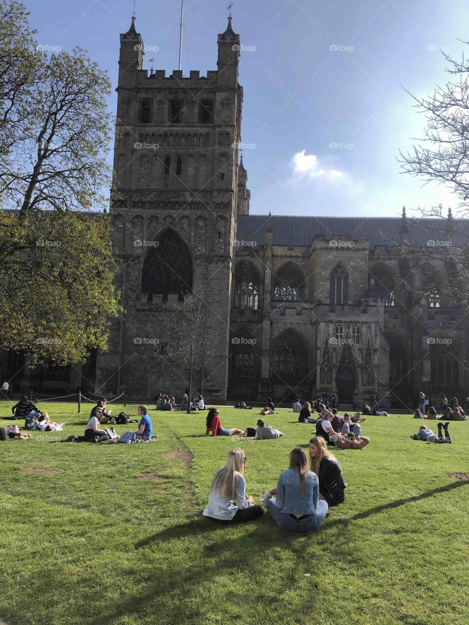 A side view of this historic icon that is Exeter Cathedral, with plenty enjoying summer in April 2019