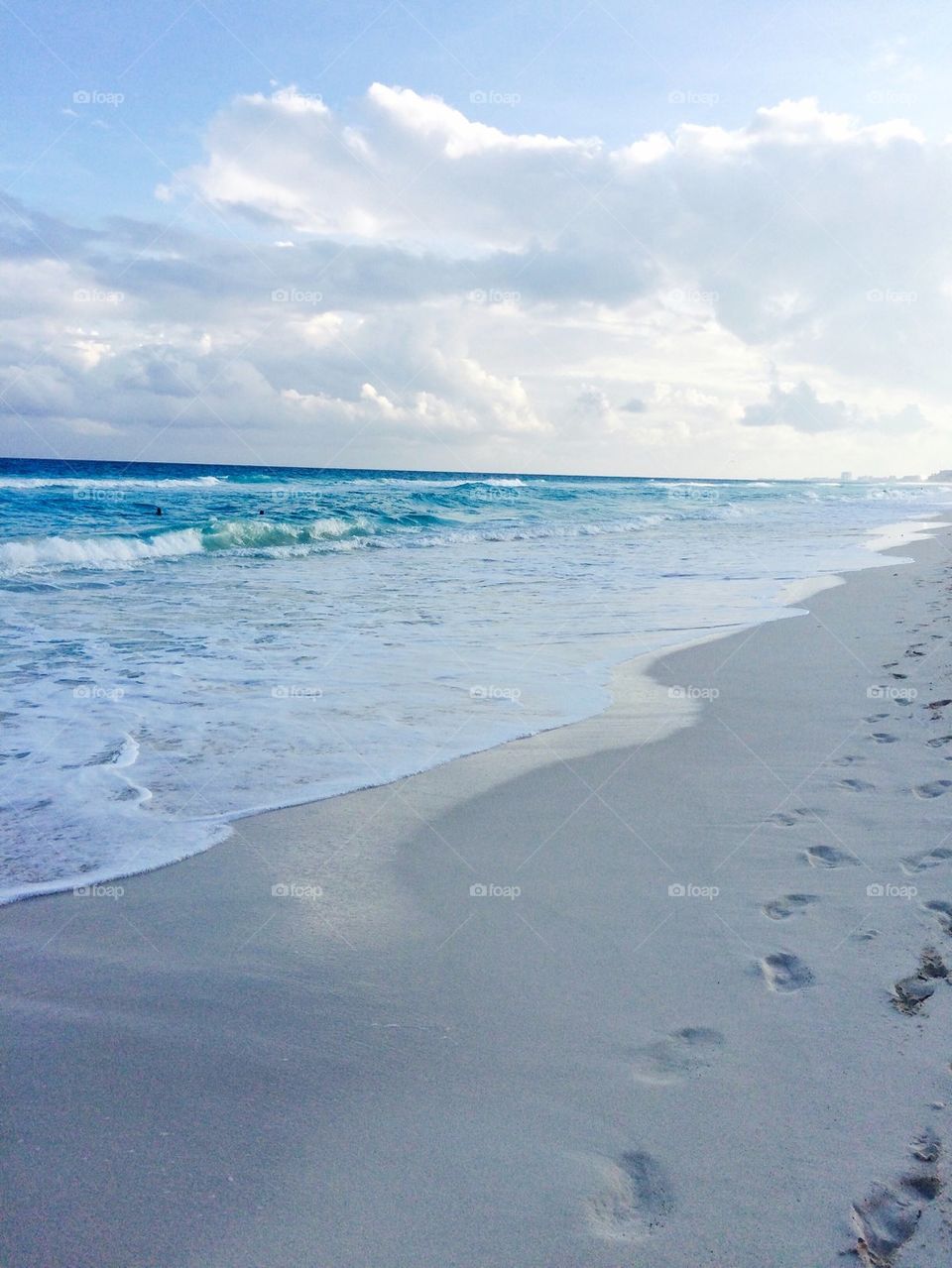 Footprints on sand at beach