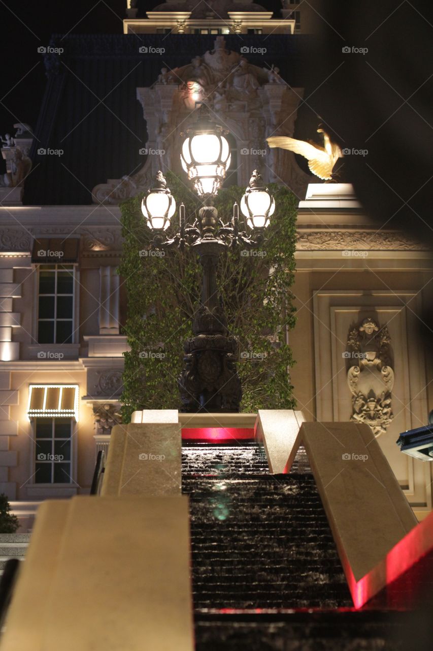 staircase and a lantern, against the backdrop of a lighted building in the night, Macau Street
