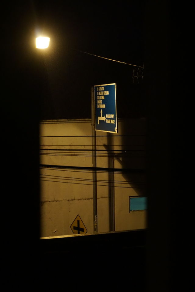 street sign from window view at night