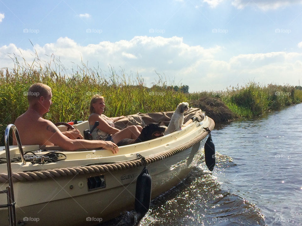 Couple with funny dog in boat